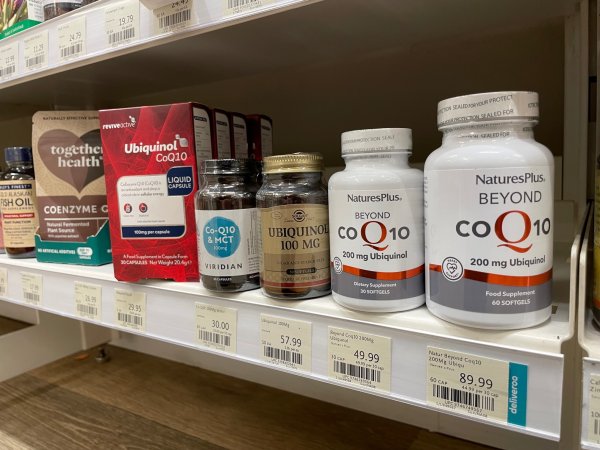 Different CoQ10 supplement brands at a health store CoQ10