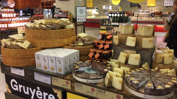Different types of cheese on display in a shop Different types of cheese on display in a shop