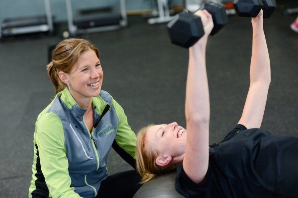 Personal trainer guiding a client to fitness success A personal trainer